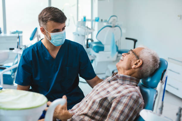 Dental places that take medicare near me - dentist cleaning mans teeth